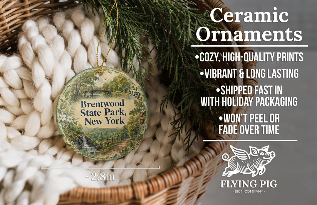 Ceramic ornaments, including a round ornament with a scenic print of Brentwood State Park, New York, hanging in a basket with pine branches.
