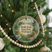 A round ornament hanging on a Christmas tree, featuring a scenic image of a deer in a forest and the text "Bridle Trails State Park, Washington".