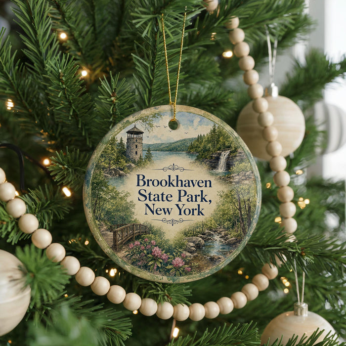 A round ornament hanging on a Christmas tree, featuring a scenic image of Brookhaven State Park in New York.