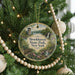 A round ornament hanging on a Christmas tree, featuring a scenic image of Brookhaven State Park in New York.