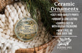 Ceramic ornaments, specifically Calamus State Recreation Area, Nebraska ornaments, are displayed in a basket with pine branches. The text highlights the ornaments as "Cozy, High-quality prints" and "Vibrant & long lasting", with a description of their shipping speed and packaging. The image also includes a logo for "Flying Pig - SIGN COMPANY".