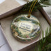 A decorative ornament in a box, featuring a scenic landscape of Caledonia State Park, Pennsylvania.