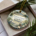 A decorative ornament in a box, featuring a scenic image of Camano Island State Park in Washington.