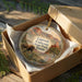 A decorative ornament in a wooden box, featuring a scenic image of the Caprock Canyons State Park in Texas.