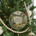 A Christmas tree ornament featuring a scenic image of Carniffe Ferry Battlefield State Park, West Virginia, with a path leading to a bridge and a small cabin.