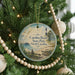 A round ornament hanging on a Christmas tree, featuring a scenic image of Carolina Beach State Park in North Carolina.
