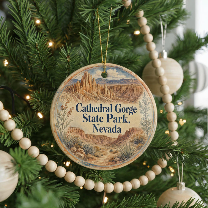 A round ornament hanging on a Christmas tree, featuring a scenic image of the Cathedral Gorge State Park in Nevada.