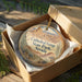 A decorative ornament in a cardboard box, featuring an illustration of the Cathedral Gorge State Park in Nevada.