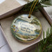 A decorative ornament in a box, featuring a scenic image of Cayuga Lake State Park in New York.
