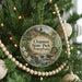 A round ornament hanging on a Christmas tree, featuring a scenic image of Chapman State Park in Pennsylvania.