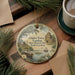 A decorative ornament featuring a scenic image of Charles Towne Landing, a historic site in South Carolina, with a boat and palm trees in the background.