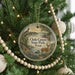 A round ornament on a Christmas tree, featuring a scenic image of Choque Canyon State Park, Texas, with a bird and deer in the foreground.