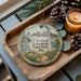 A decorative ornament featuring a scenic view of Cleveland Lakefront State Park, Ohio, with a lighthouse and a boat in the background.