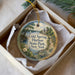 A decorative ornament in a box, featuring a scenic image of Cold Spring Harbor State Park in New York.