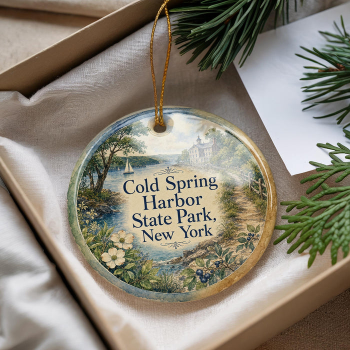 A decorative ornament with a scenic landscape of Cold Spring Harbor State Park, New York, featuring a ship and a path through the park.