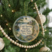 A round ornament hanging on a Christmas tree, featuring a scenic image of Cold Spring Harbor State Park in New York.