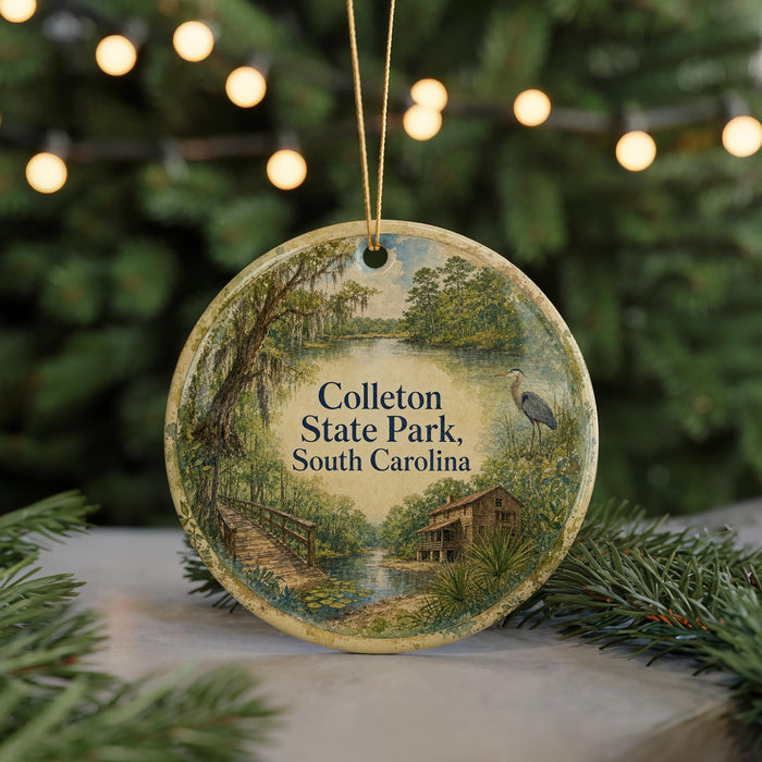 A round ornament with a painting of a park scene, featuring a bridge, trees, and a bird, hanging from a string.