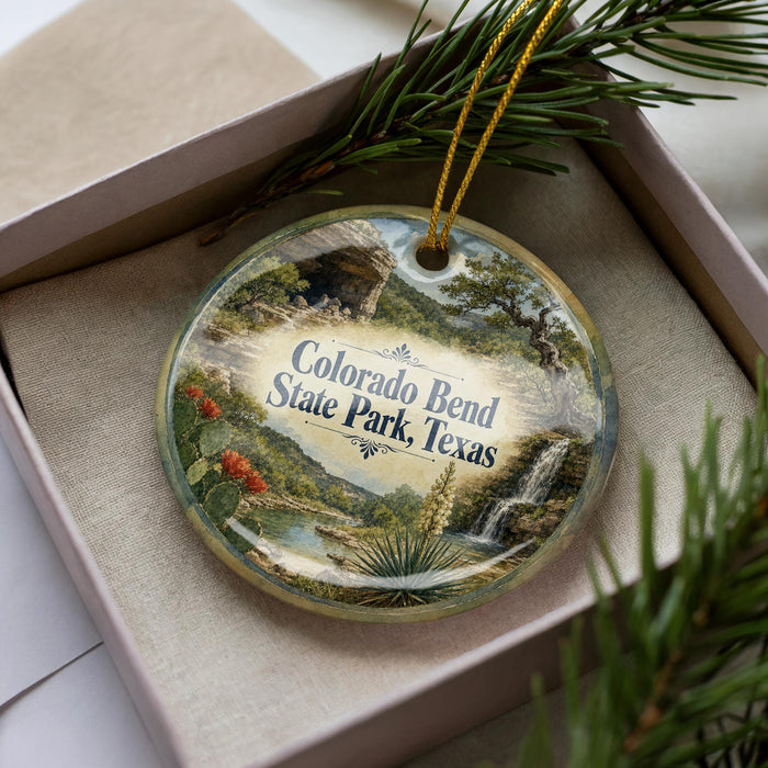 A decorative ornament featuring a scenic landscape of Colorado Bend, Texas, with a waterfall and desert elements.