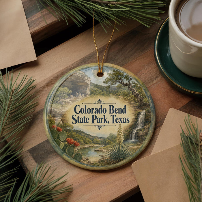 A decorative ornament featuring a scenic landscape of Colorado Bend State Park, Texas, with a waterfall and desert backdrop.