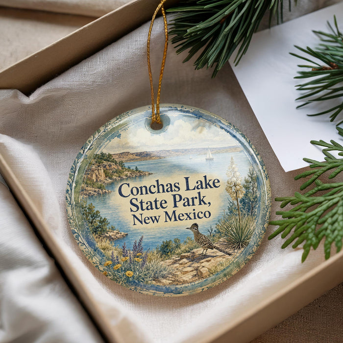 A decorative ornament with a scenic landscape of Conchas Lake State Park, New Mexico, featuring a bird, a boat, and a desert landscape.