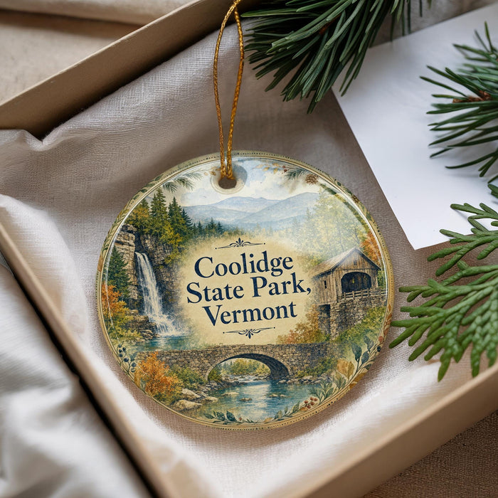 A decorative ornament with a scenic image of Coolidge State Park, Vermont, hanging from a string.