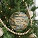A round ornament on a Christmas tree, featuring a scenic image of Cooper Lake State Park, Texas, with a deer and a bird in the foreground.