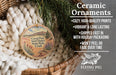 Ceramic ornaments, featuring a round ornament with a desert landscape and text, are displayed in a woven basket.