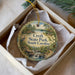 A decorative ornament in a box, featuring a scenic landscape with a waterfall and a bird, with the text "Croft State Park, South Carolina" prominently displayed.