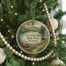 A round ornament hanging on a Christmas tree, featuring a scenic image of Crystal Lake State Park in Vermont.