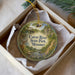 A decorative ornament in a white box, featuring a scenic image of the Cuivre River State Park in Missouri.