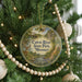 A round ornament hanging on a Christmas tree, featuring a scenic image of the Cuivre River State Park in Missouri.
