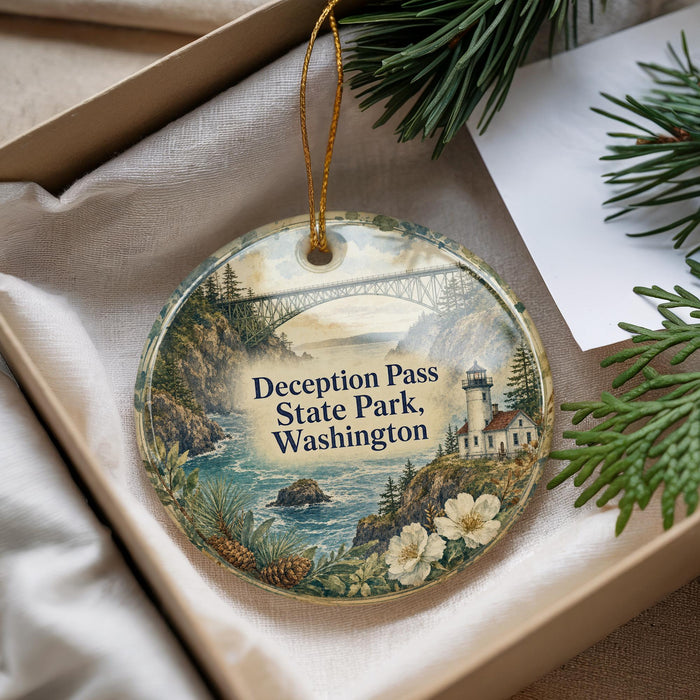 A decorative ornament with a scenic landscape of a bridge, lighthouse, and water, featuring the text "Deception Pass State Park, Washington".