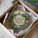 A decorative ornament in a box, featuring a scenic image of Deer Mountain Campground, State Park, and New Hampshire.