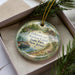 A decorative ornament in a box, featuring a scenic image of the Delaware and Raisin Canal in New Jersey.