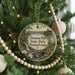 A round ornament hanging on a Christmas tree, featuring a scenic image of Denton Hill State Park in Pennsylvania.