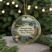 A decorative ornament featuring a scenic landscape of Detroit Lake, Michigan, with a boat on the water and pine trees in the background.
