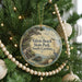 A round ornament hanging on a Christmas tree, featuring a scenic image of Edisto Beach State Park, South Carolina.