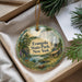 A decorative ornament with a scenic landscape of Evangola State Park, New York, featuring a waterfall, pine trees, and a cabin.