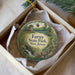 A round ornament with a scenic landscape of Farny State Park in New Jersey, featuring a building, trees, and a river.