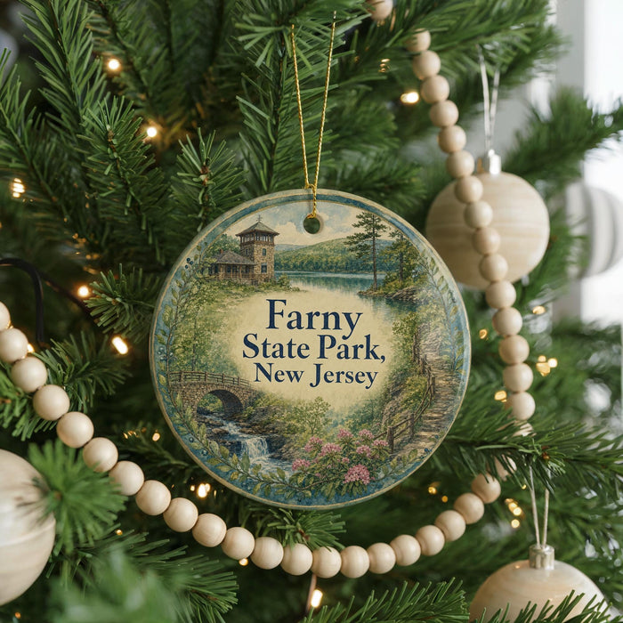 A round ornament on a Christmas tree, featuring a scenic landscape with a bridge and a house, with the text "Farny State Park, New Jersey" displayed on it.