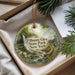 A decorative ornament with a scenic image of Fillmore Glen State Park, New York, hanging from a string.