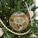 A Christmas tree decorated with ornaments, including a circular ornament with a scenic image of buffalo jumping over a river and the text "First People, Buffalo Jump State Park, Montana".