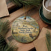 A decorative ornament featuring a scenic image of Fort Abraham Lincoln State Park, North Dakota, with a buffalo in the foreground and a pine tree in the background.