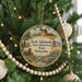 A round ornament hanging on a Christmas tree, featuring an illustration of Fort Atkinson State Historical Park in Nebraska.