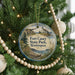 A round ornament hanging on a Christmas tree, featuring a scenic image of Fort Casey State Park in Washington.