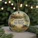 A round ornament featuring a painting of Fort Hartsuff State Historical Park in Nebraska, with a wagon and a cannon in the foreground.