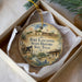 A decorative ornament in a box, featuring an illustration of Fort Lancaster, Texas, with a cannon and other historical elements.