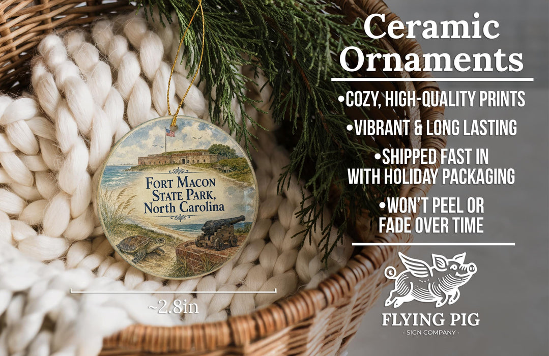 Ceramic ornaments, featuring a round ornament with a picture of Fort Macon State Park, North Carolina, hanging from a wicker basket.