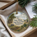 A decorative ornament with a scenic image of Fort Pillow State Historic Park in Tennessee, featuring a wooden cabin, a river, and a mountain landscape.