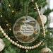 A round ornament hanging on a Christmas tree, featuring a scenic image of Fort Pillow State Historic Park in Tennessee.